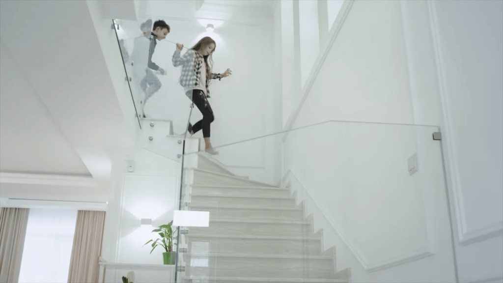 Children coming down a modern glass staircase