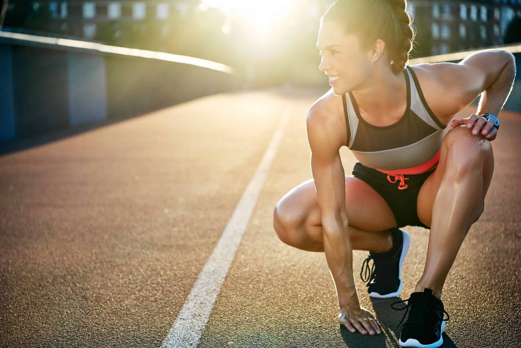 Girl with hand flat on floor at race track